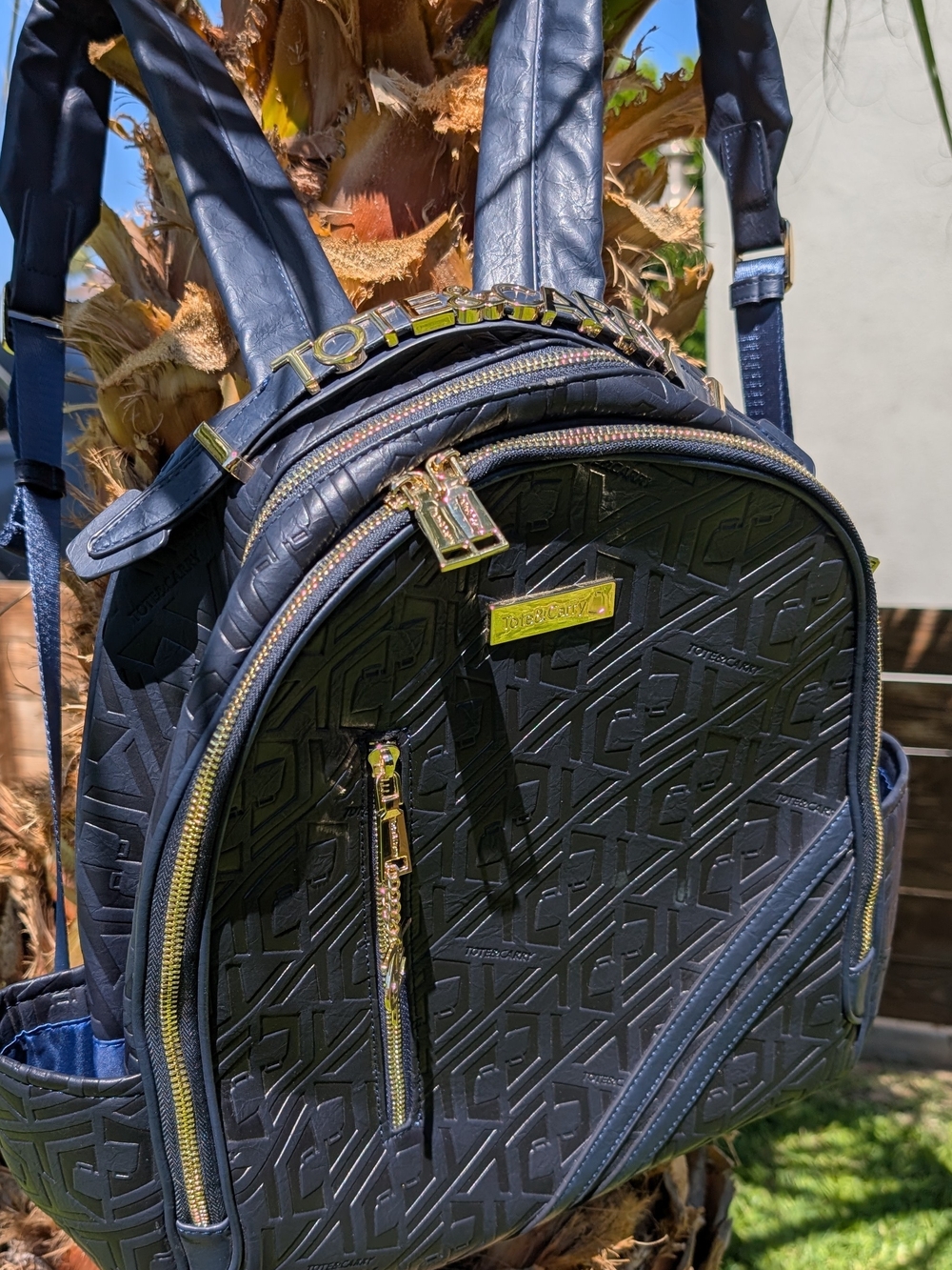 Tote & Carry Black Embossed Backpack with Gold Hardware